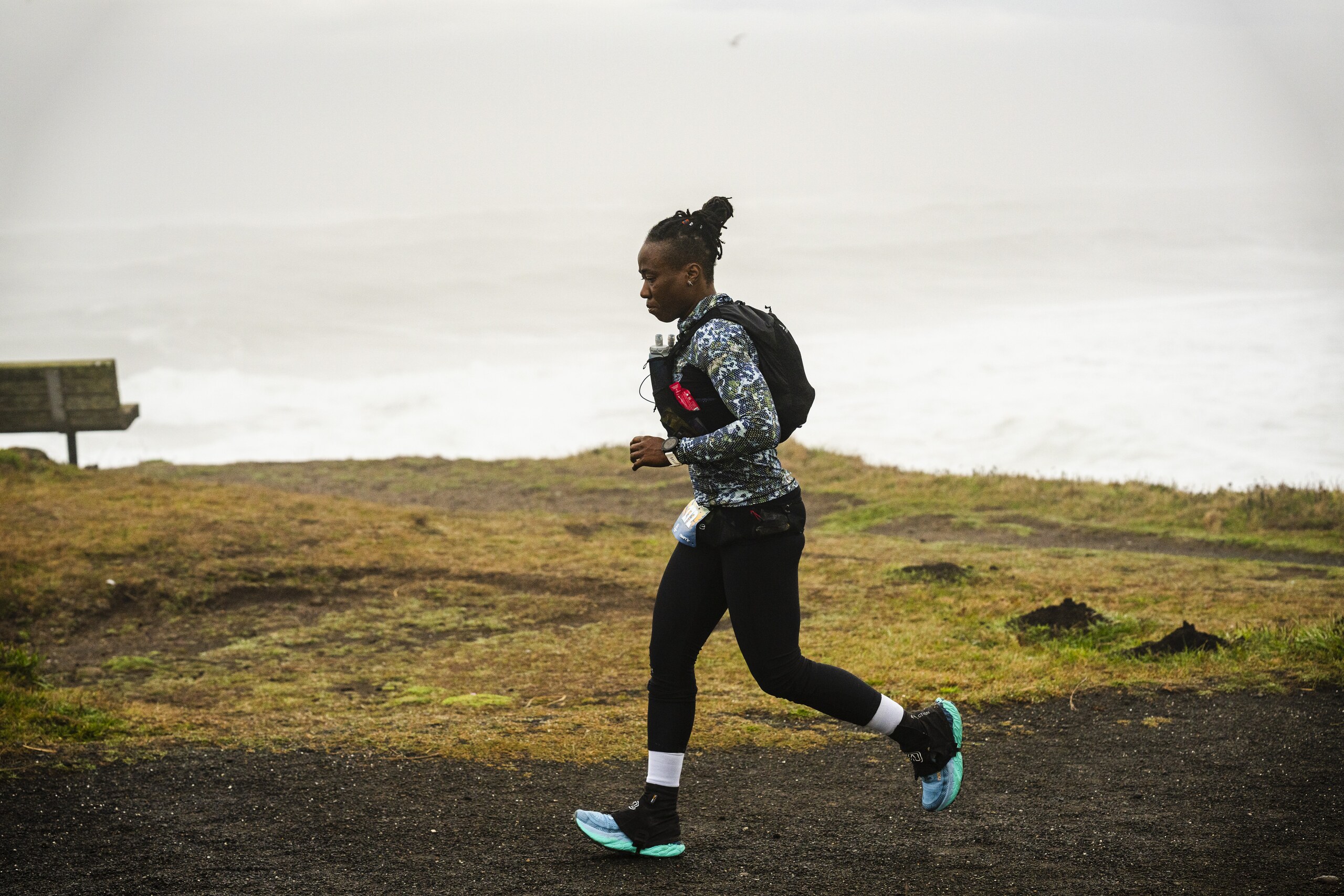 Runner moving through open trail terrain